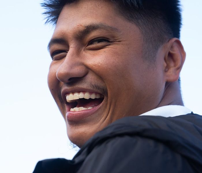 Person smiling and stretching, feeling energetic and positive.